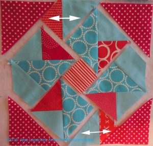 Sew small red triangles to solid triangles