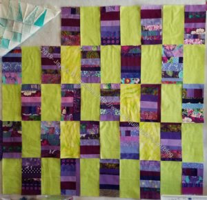 Purple strip donation quilt with yellow-green